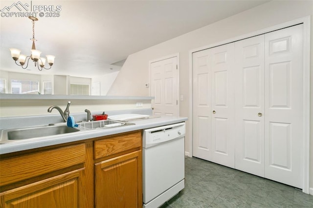kitchen featuring white dishwasher, a sink, a chandelier, decorative light fixtures, and brown cabinets