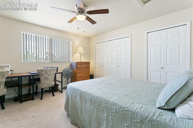 bedroom with carpet flooring, multiple closets, and ceiling fan