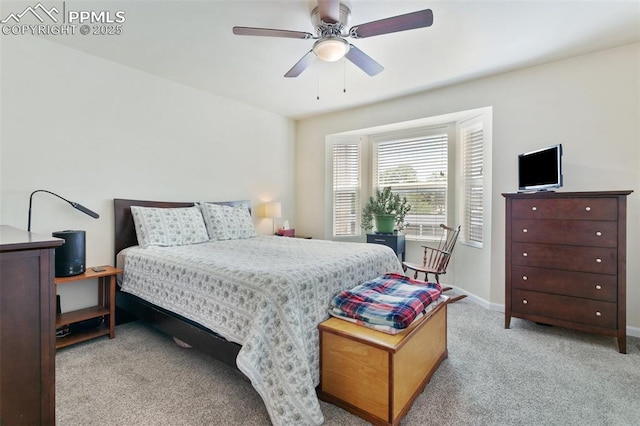 carpeted bedroom with baseboards and a ceiling fan
