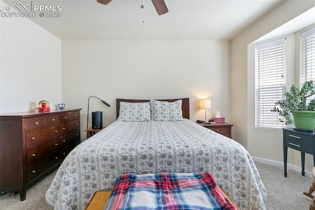 carpeted bedroom with baseboards and a ceiling fan