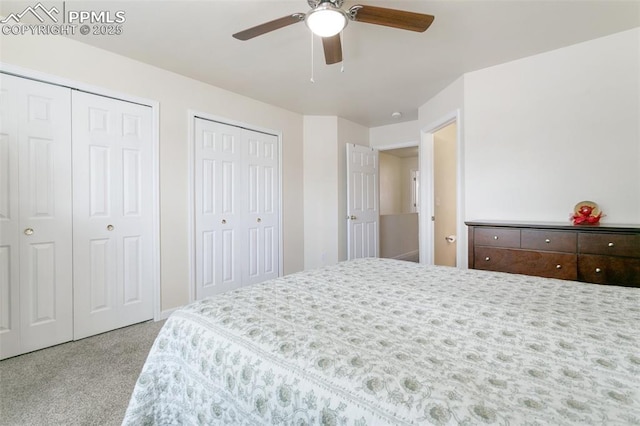 bedroom with carpet, two closets, and ceiling fan