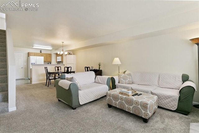 living area featuring stairway, a chandelier, light carpet, and baseboards