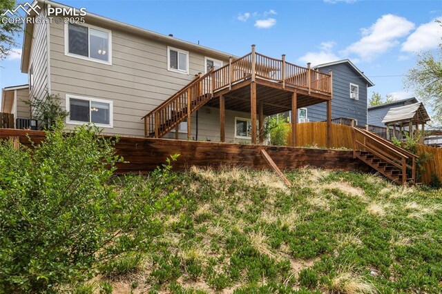 4650 Cassidy St, Colorado Springs, CO 80911 - rear view of house featuring a deck, stairway, and fence