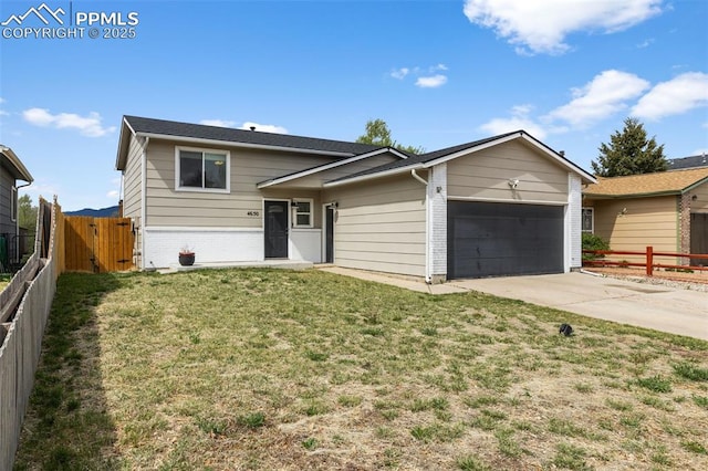 4650 Cassidy St, Colorado Springs, CO 80911 - tri-level home featuring a front yard, brick siding, fence, and a garage