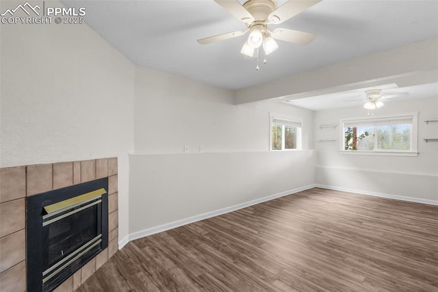 4650 Cassidy St, Colorado Springs, CO 80911 - unfurnished living room featuring baseboards, a fireplace, ceiling fan, and wood finished floors