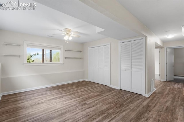 4650 Cassidy St, Colorado Springs, CO 80911 - unfurnished bedroom with baseboards, two closets, and wood finished floors