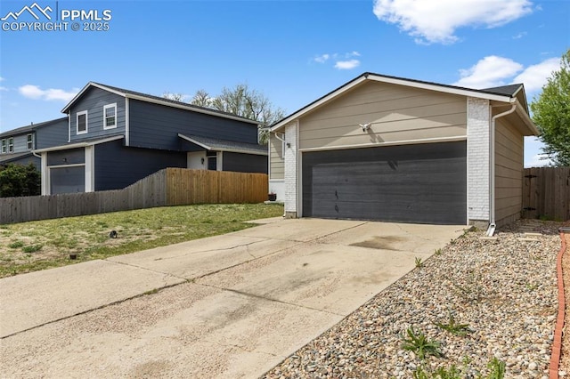 4650 Cassidy St, Colorado Springs, CO 80911 - view of front of property with driveway, brick siding, a garage, and fence