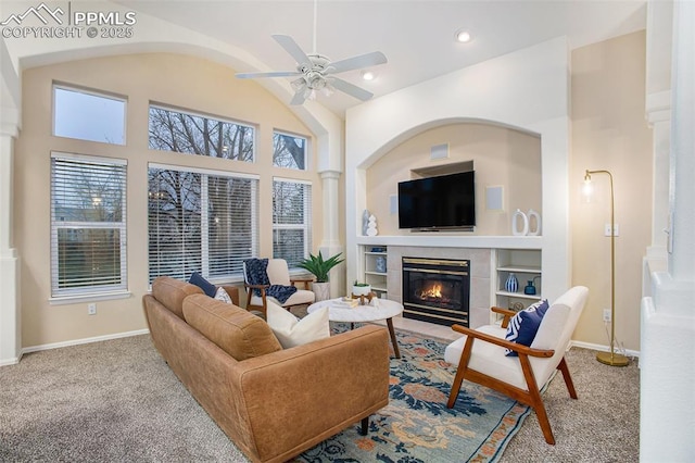 living area featuring carpet floors, a fireplace, ceiling fan, built in shelves, and recessed lighting