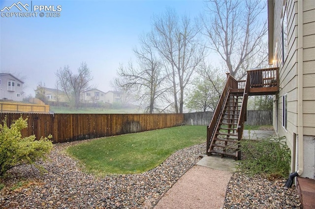 view of yard with stairway, a wooden deck, and a residential view