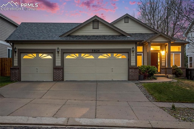 view of front of property featuring an attached garage, concrete driveway, brick siding, roof with shingles, and fence