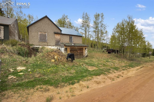 910 Victor Ave, Goldfield, CO 80860 - view of home's exterior with a garage and metal roof