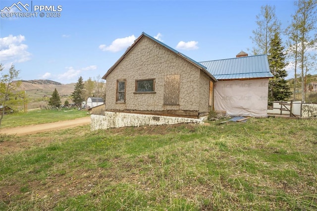 910 Victor Ave, Goldfield, CO 80860 - view of home's exterior featuring metal roof, a mountain view, and a chimney