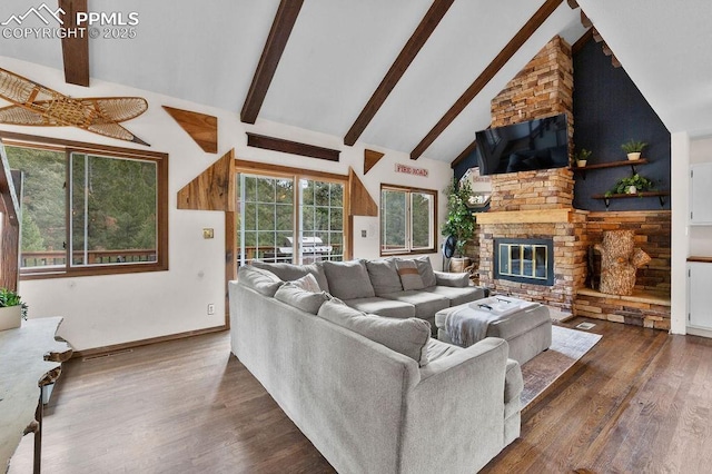 9410 Shoshone Rd, Cascade, CO 80809 - living room featuring wood finished floors, beamed ceiling, high vaulted ceiling, a large fireplace, and baseboards