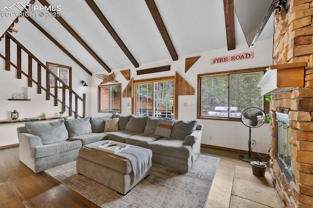 9410 Shoshone Rd, Cascade, CO 80809 - living area featuring wood finished floors, stairway, beam ceiling, high vaulted ceiling, and baseboards