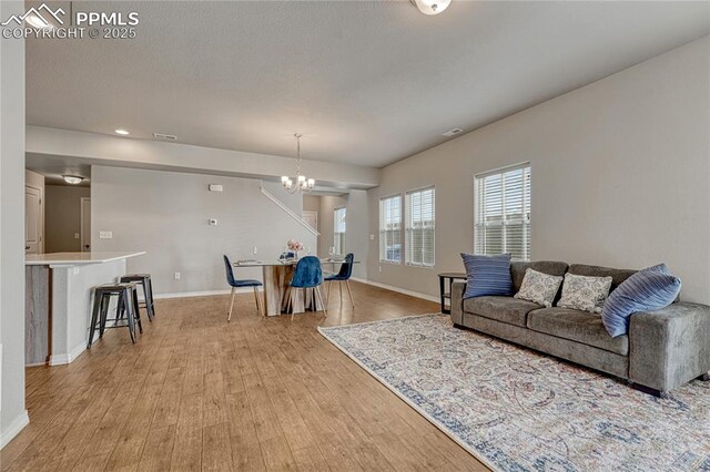 4342 Kaolin Ct, Colorado Springs, CO 80938 - living room featuring light wood-style flooring, a chandelier, and recessed lighting