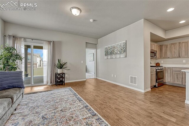 4342 Kaolin Ct, Colorado Springs, CO 80938 - living room with light wood finished floors and recessed lighting