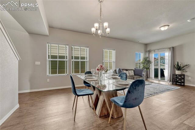 4342 Kaolin Ct, Colorado Springs, CO 80938 - dining space with wood finished floors and a chandelier