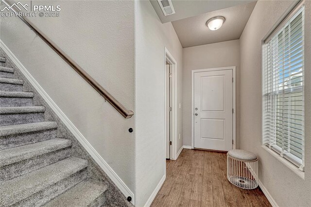 4342 Kaolin Ct, Colorado Springs, CO 80938 - stairs with wood finished floors and baseboards