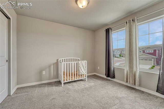 4342 Kaolin Ct, Colorado Springs, CO 80938 - carpeted bedroom featuring baseboards and a nursery area