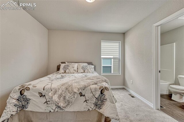 4342 Kaolin Ct, Colorado Springs, CO 80938 - bedroom featuring a textured wall, a textured ceiling, ensuite bathroom, and carpet flooring