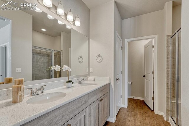 4342 Kaolin Ct, Colorado Springs, CO 80938 - full bath with a shower stall, wood finished floors, and double vanity