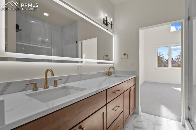 full bathroom featuring marble look tiles, double vanity, a stall shower, and baseboards