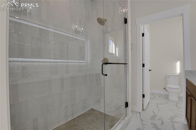 full bath featuring a shower stall, vanity, toilet, and marble look tile flooring
