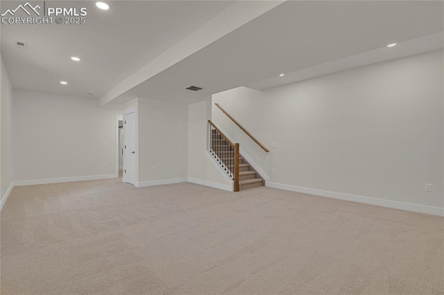 below grade area with recessed lighting, stairs, baseboards, and light colored carpet