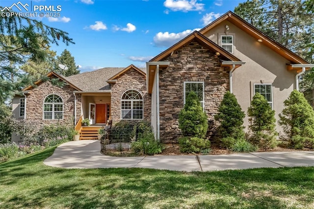 8174 Inca Rd, Larkspur, CO 80118 - traditional-style house featuring stone siding, stucco siding, and a front yard