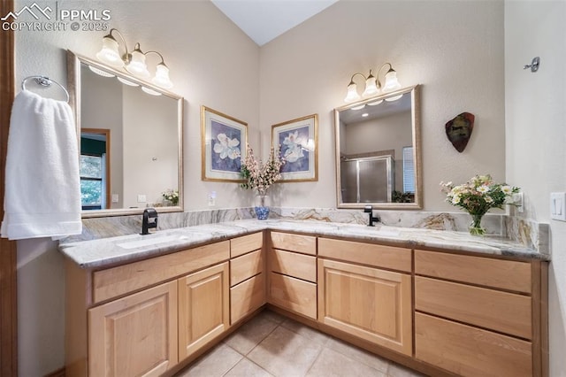 8174 Inca Rd, Larkspur, CO 80118 - bathroom featuring tile patterned floors, double vanity, and a shower with door