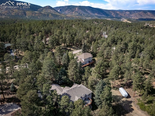 8174 Inca Rd, Larkspur, CO 80118 - view of property location with a heavily wooded area and a mountain backdrop