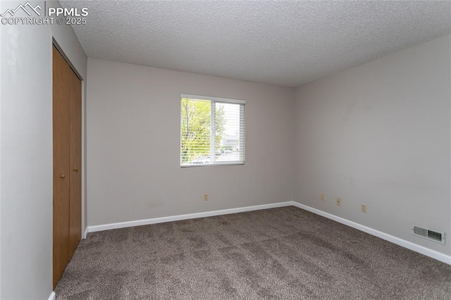 1295 Soaring Eagle Dr, Colorado Springs, CO 80915 - unfurnished bedroom with carpet, a textured ceiling, a closet, and baseboards
