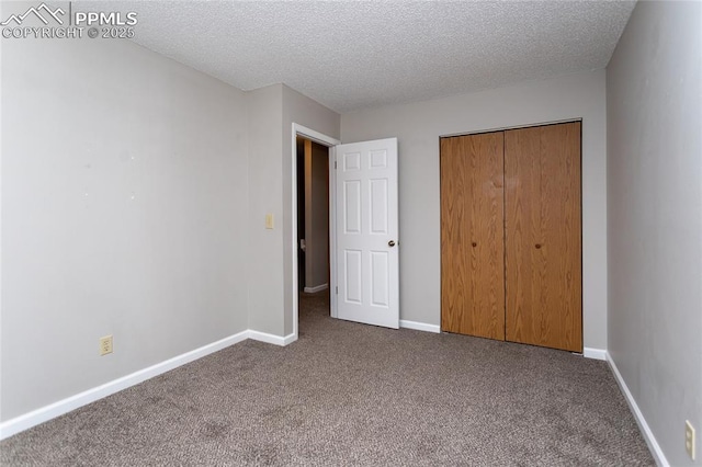 1295 Soaring Eagle Dr, Colorado Springs, CO 80915 - unfurnished bedroom with carpet floors, a textured ceiling, a closet, and baseboards