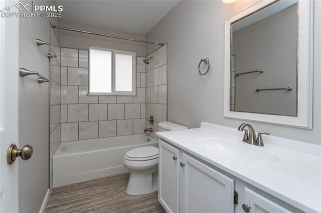 1295 Soaring Eagle Dr, Colorado Springs, CO 80915 - bathroom featuring toilet, wood finished floors, vanity, and shower / washtub combination