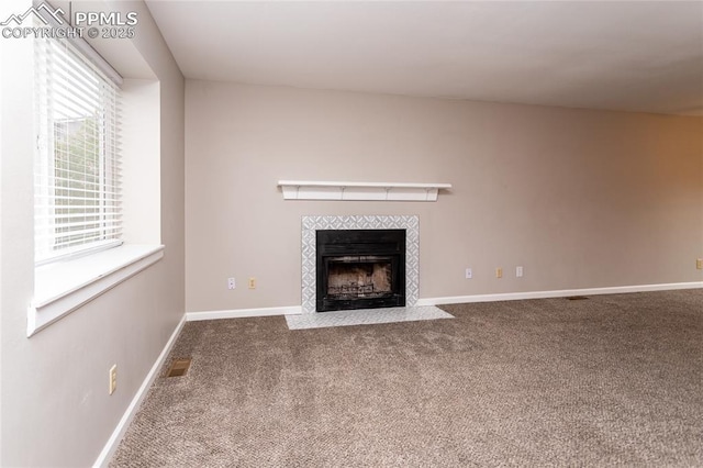 1295 Soaring Eagle Dr, Colorado Springs, CO 80915 - unfurnished living room featuring carpet, a tiled fireplace, and baseboards