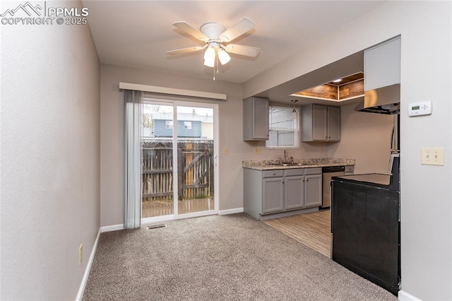 1295 Soaring Eagle Dr, Colorado Springs, CO 80915 - kitchen featuring gray cabinetry, wall chimney exhaust hood, stainless steel dishwasher, a sink, and a ceiling fan