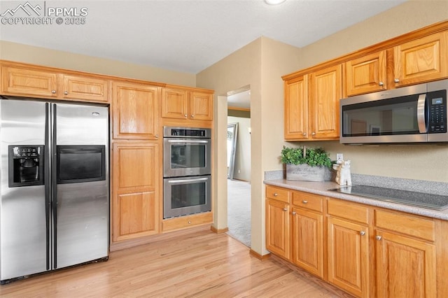 11985 Hanging Valley Way, Colorado Springs, CO 80921 - kitchen with appliances with stainless steel finishes, light wood-style floors, and light countertops