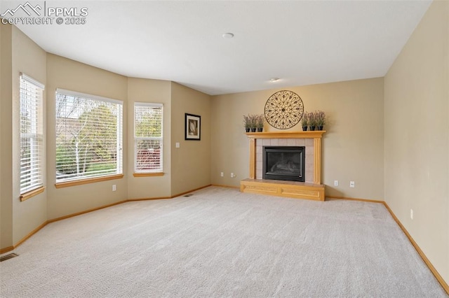 11985 Hanging Valley Way, Colorado Springs, CO 80921 - unfurnished living room featuring carpet, baseboards, and a fireplace