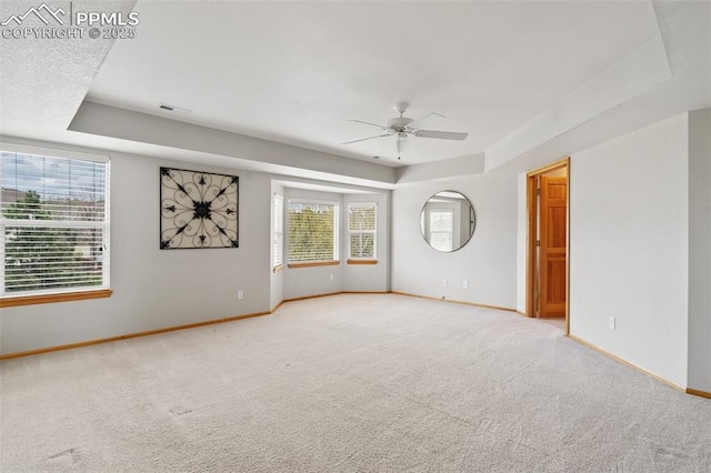 11985 Hanging Valley Way, Colorado Springs, CO 80921 - carpeted empty room with a tray ceiling, a ceiling fan, and baseboards