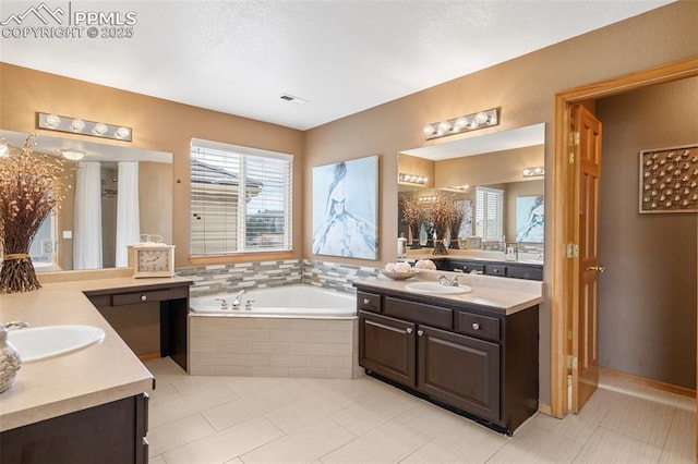 11985 Hanging Valley Way, Colorado Springs, CO 80921 - bathroom featuring a garden tub, two vanities, and tile patterned flooring