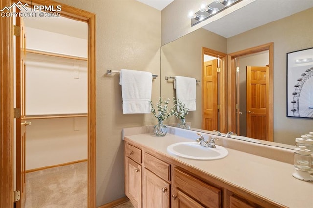 11985 Hanging Valley Way, Colorado Springs, CO 80921 - bathroom featuring vanity and a walk in closet