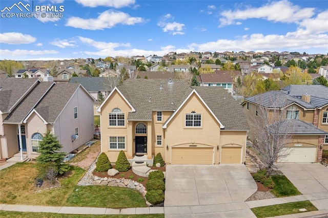 11985 Hanging Valley Way, Colorado Springs, CO 80921 - traditional home with a residential view, driveway, stucco siding, and an attached garage
