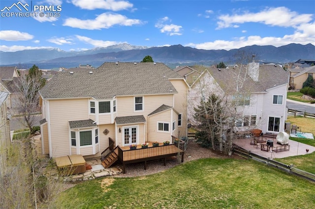 11985 Hanging Valley Way, Colorado Springs, CO 80921 - back of house with a deck with mountain view, a yard, a patio, and roof with shingles