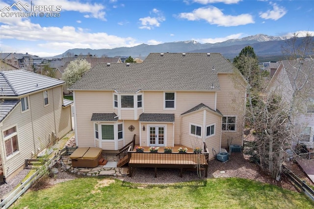 11985 Hanging Valley Way, Colorado Springs, CO 80921 - back of property featuring a deck with mountain view, a shingled roof, and central AC unit
