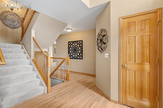 11985 Hanging Valley Way, Colorado Springs, CO 80921 - stairs with wood finished floors and baseboards