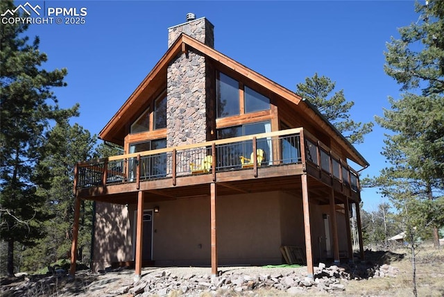 78 Powderhorn Ln, Florissant, CO 80816 - back of property with a chimney and a wooden deck