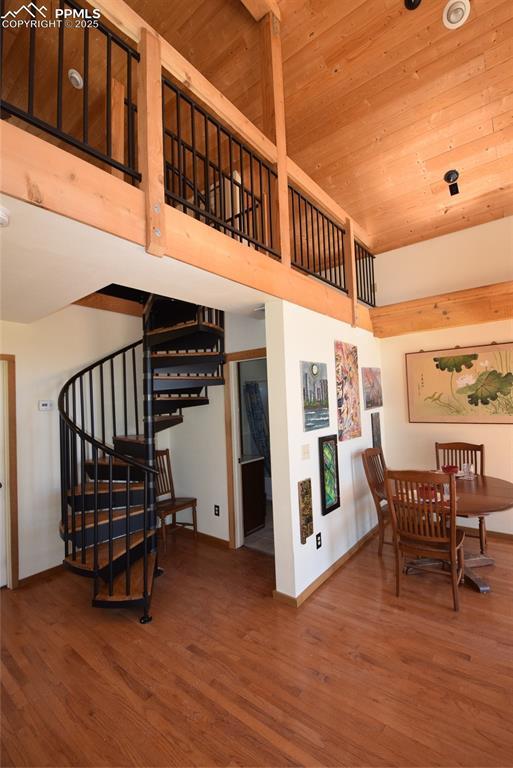 78 Powderhorn Ln, Florissant, CO 80816 - stairway with wood finished floors, wooden ceiling, baseboards, and a towering ceiling