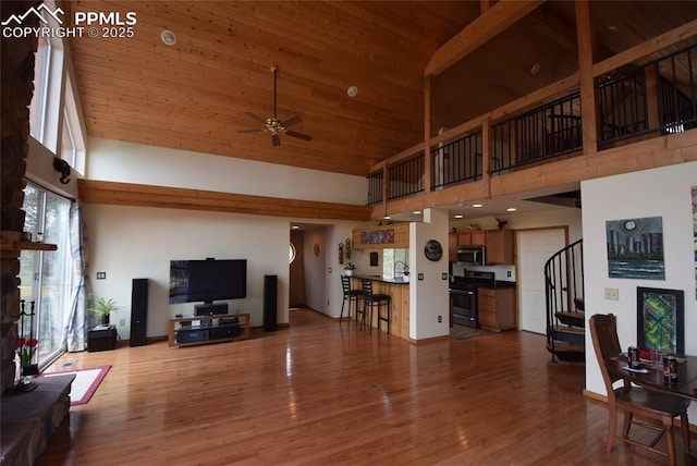 78 Powderhorn Ln, Florissant, CO 80816 - living room with high vaulted ceiling, stairs, ceiling fan, wood finished floors, and wooden ceiling