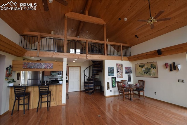78 Powderhorn Ln, Florissant, CO 80816 - living room featuring ceiling fan, high vaulted ceiling, stairs, baseboards, and wood ceiling