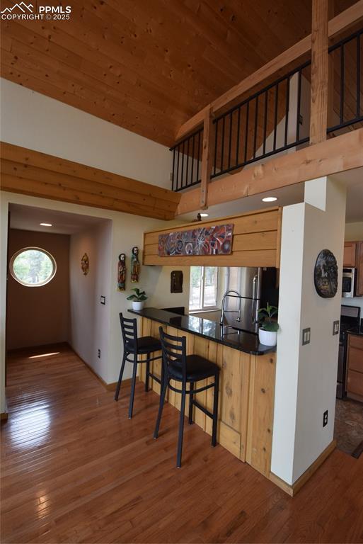 78 Powderhorn Ln, Florissant, CO 80816 - kitchen featuring appliances with stainless steel finishes, baseboards, wood finished floors, dark countertops, and wooden ceiling